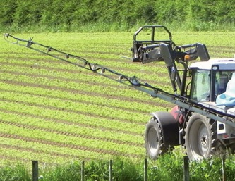 Boom wing lift in action on a sprayer