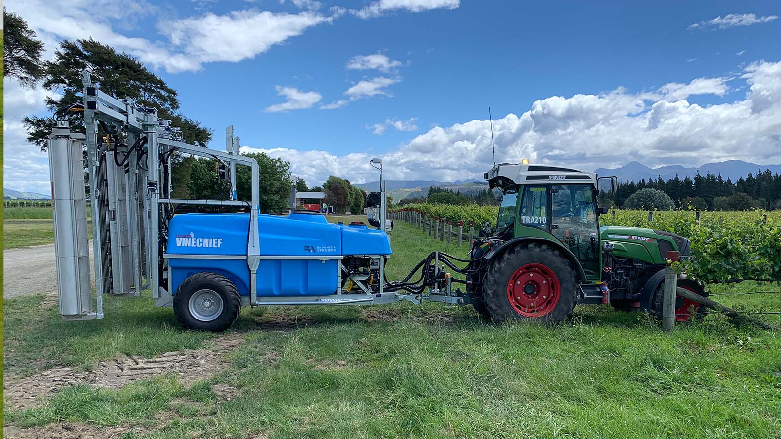 VineChief sprayer on a tractor going into a vine to spray
