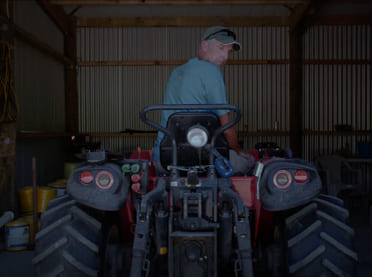 Man reversing out of a shed on a quad bike