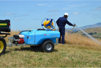 Man using a TSX Trailed Sprayer to spray weeds