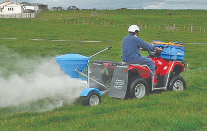 Man on a farm vehicle towing a spreader and EZI-Spot sprayer on the front