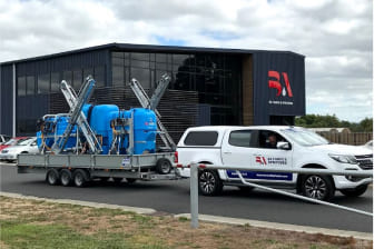 BA office in Hautapu, Cambridge with a BA branded ute carrying a trailer with three sprayers on it
