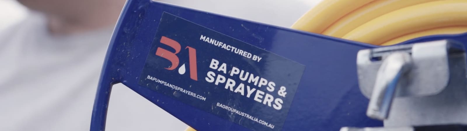 Close up of a Manufactured by BA Pumps & Sprayers sticker on a hose reel
