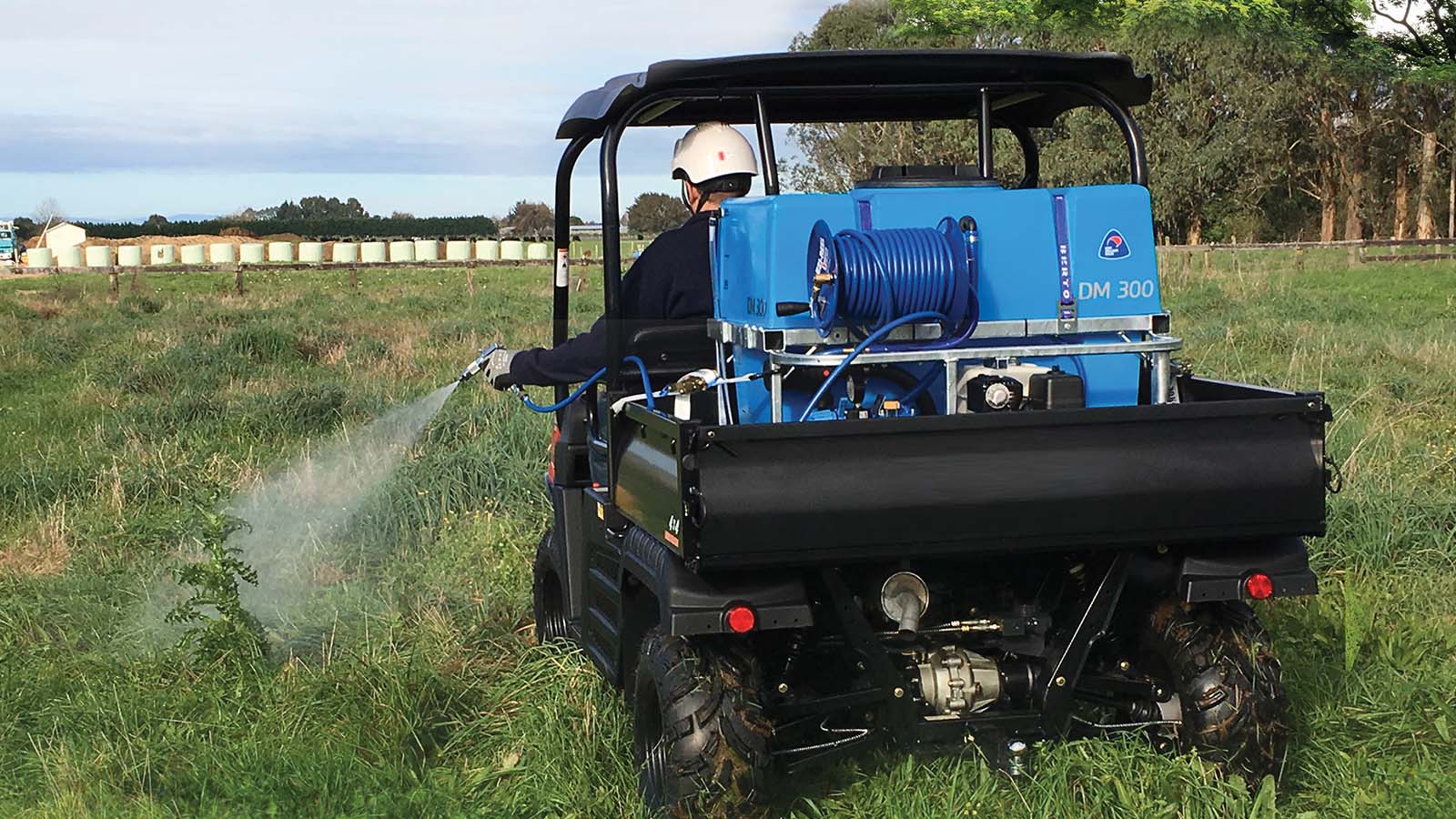 Farmer spraying weeds with the Deckmount200 spreader