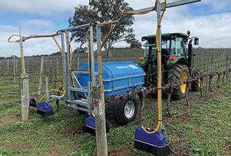 Under Vine Sprayer spraying in a vineyard