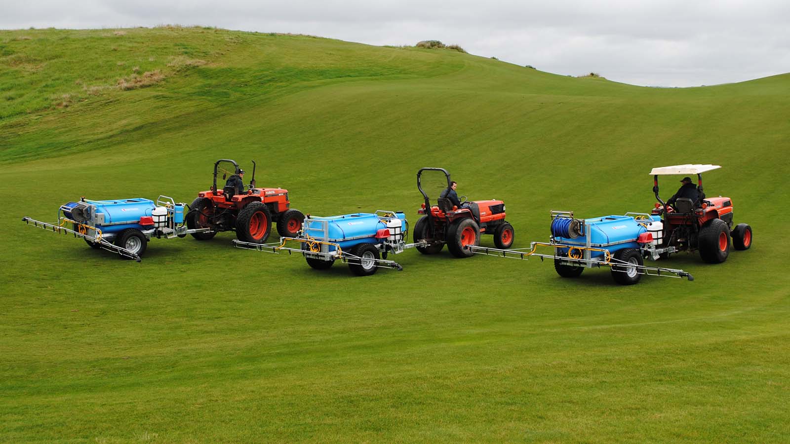Three Trailed Turf Sprayers in a row on a golf green