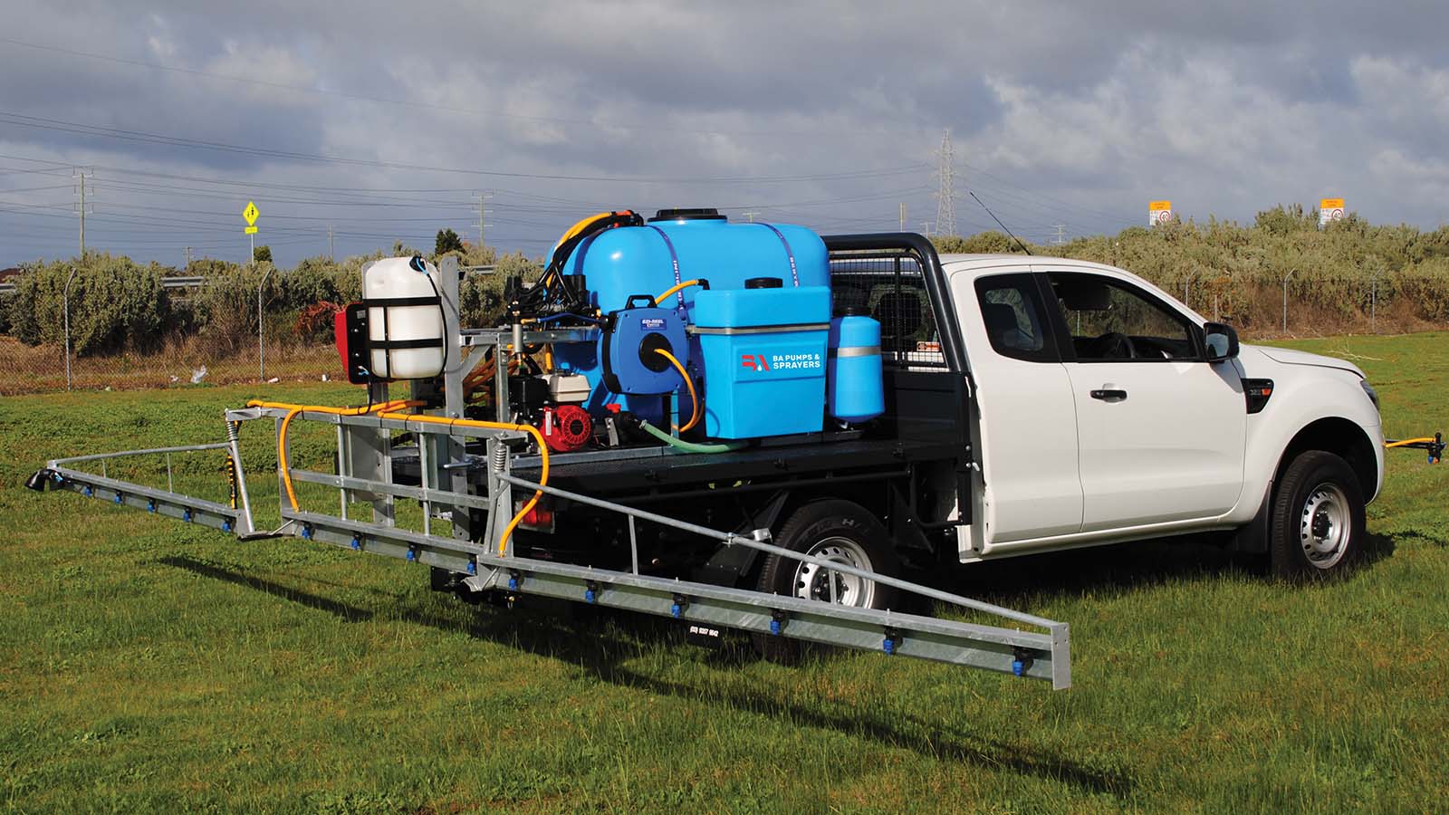 DM Boom Sprayer on the back of a Ute spraying