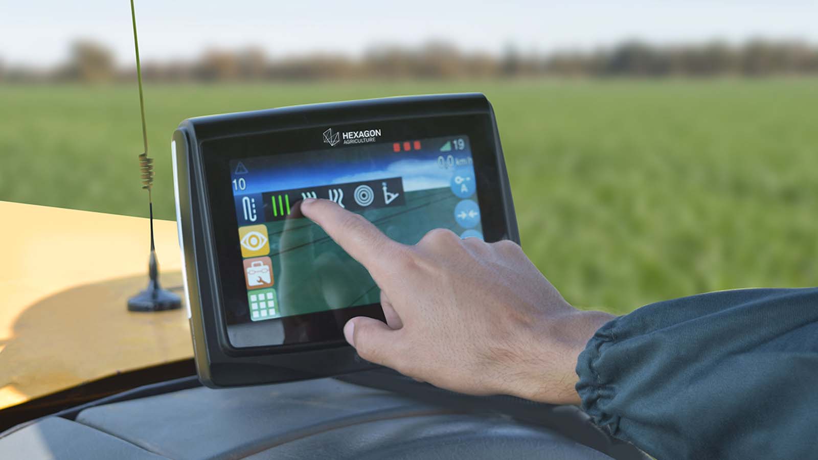 Person touching a GPS screen on a tractor