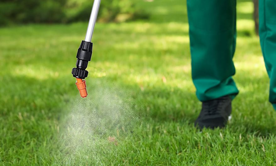 Person holding a spray gun and spraying