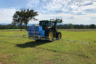 BA005 spraying in a field on a tractor