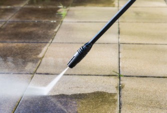 Water blaster cleaning a path