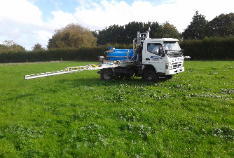 Custom Sprayer in a field with boom